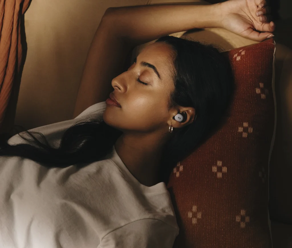 woman sleeps while wearing Smartbuds