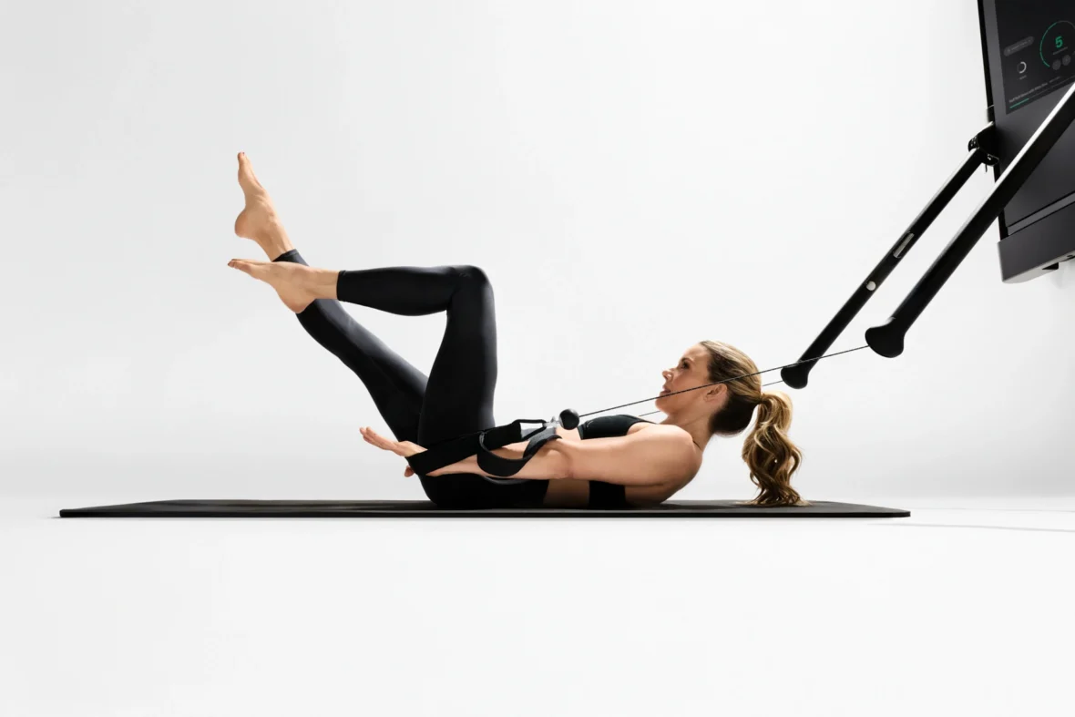 Kristin McGee does a Pilates workout on a Tonal machine
