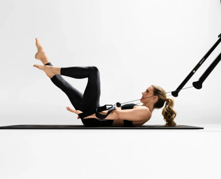 Kristin McGee does a Pilates workout on a Tonal machine