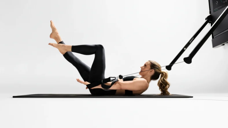 Kristin McGee does a Pilates workout on a Tonal machine