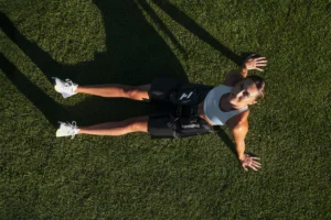 woman wears the Normatec Hip device