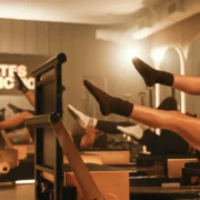 people on reformers inside a Pilates Addiction studio