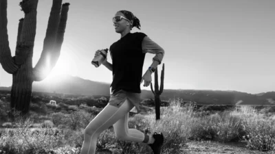 woman runs in the desert with an Apple Watch