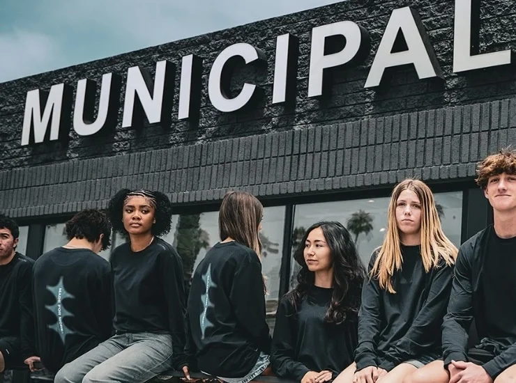 people sit outside a Municipal storefront