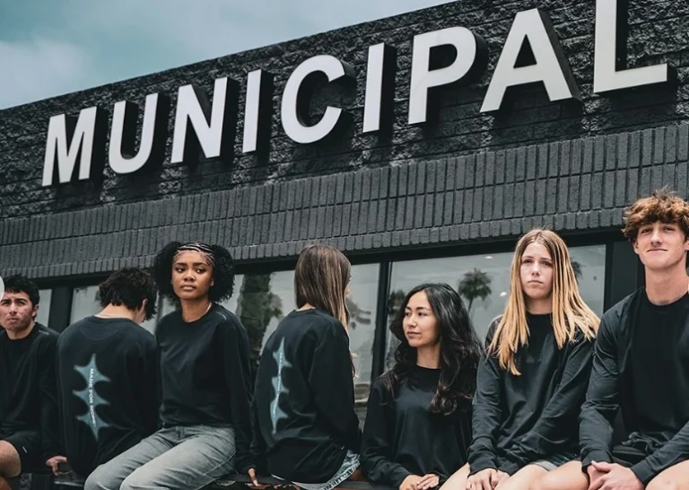 people sit outside a Municipal storefront