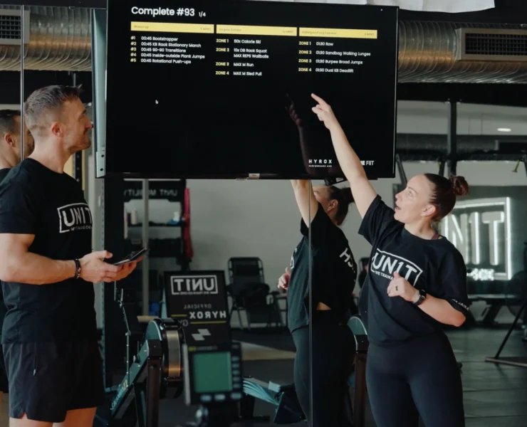 Hyrox coaches inside a gym