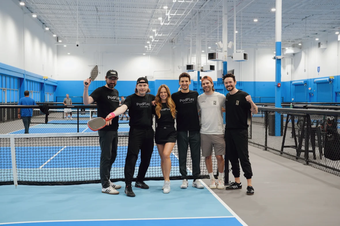 PodPlay team poses for a photo at a pickleball court