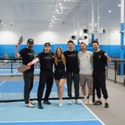 PodPlay team poses for a photo at a pickleball court