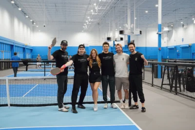 PodPlay team poses for a photo at a pickleball court