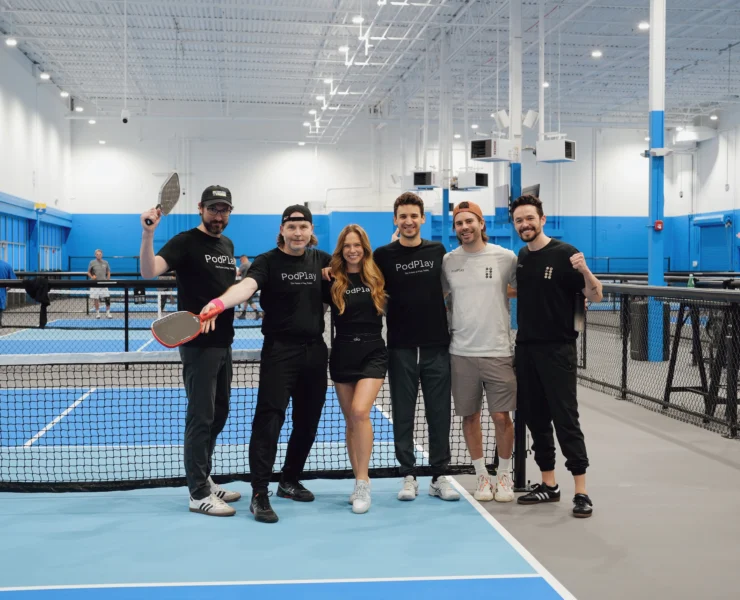 PodPlay team poses for a photo at a pickleball court