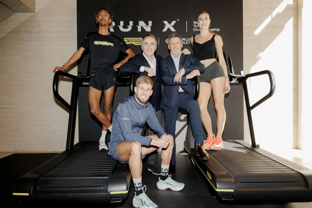 Technogym founder and CEO Nerio Alessandri, and World Athletics CEO Sebastian Coe pose for a photo with athlete