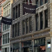 Equinox flags fly on a New York City building