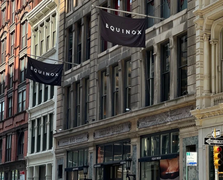 Equinox flags fly on a New York City building