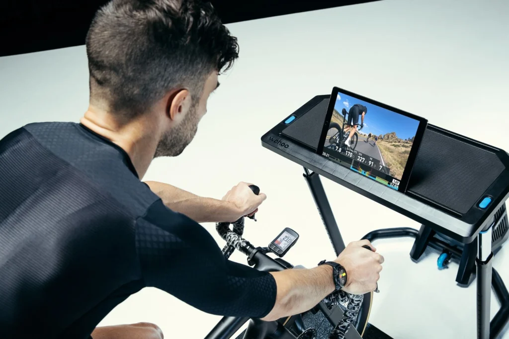 man on the Wahoo Fitness Kickr Rollr indoor trainer