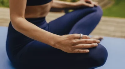 woman does yoga while wearing an Oura ring