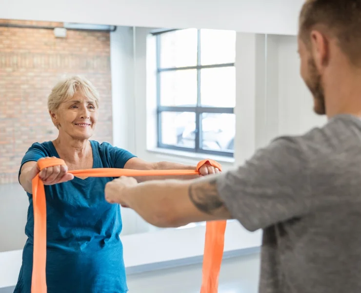 elderly woman works out with a personal trainer