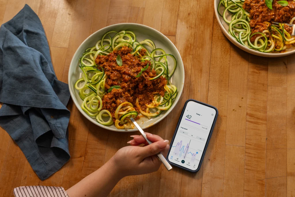woman eats a healthy spaghetti dish