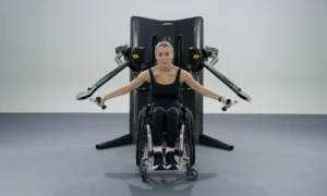 woman in a wheelchair works out with the new Life Fitness cable machine