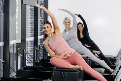 women on Pilates reformers