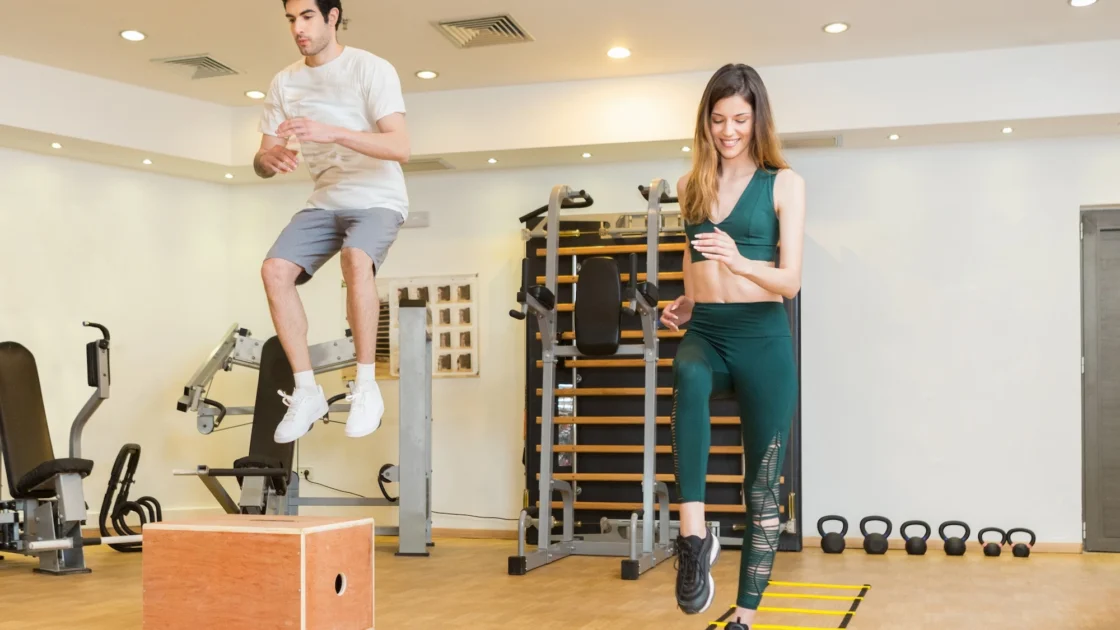 man and woman work out in a fitness studio