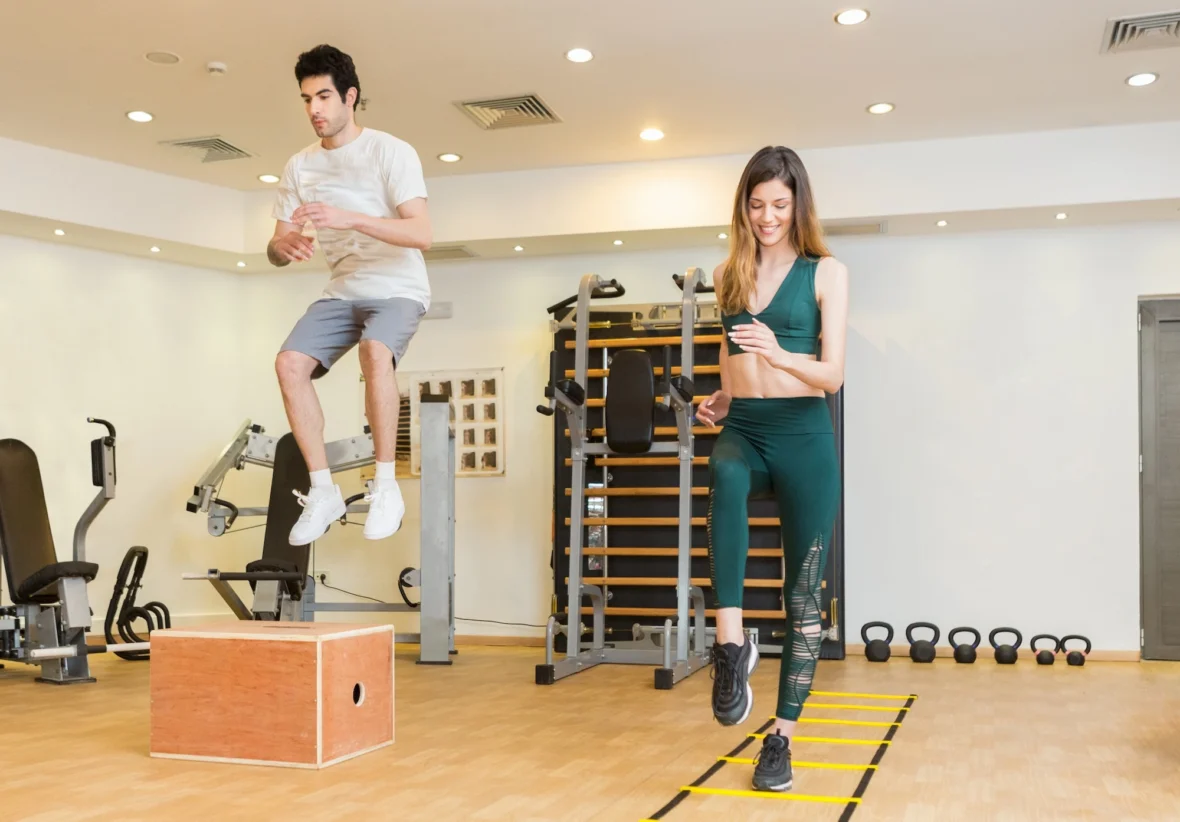 man and woman work out in a fitness studio