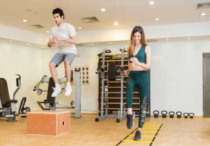 man and woman work out in a fitness studio