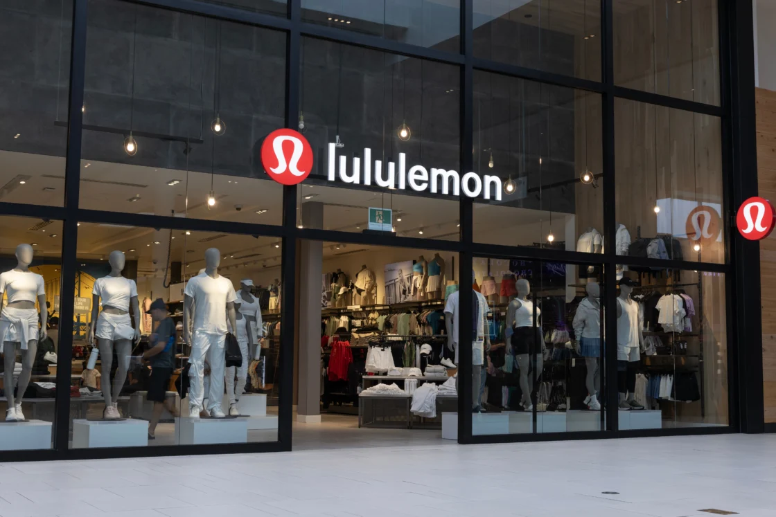 Lululemon storefront with large glass windows showcasing athletic apparel and mannequins inside a modern retail store.