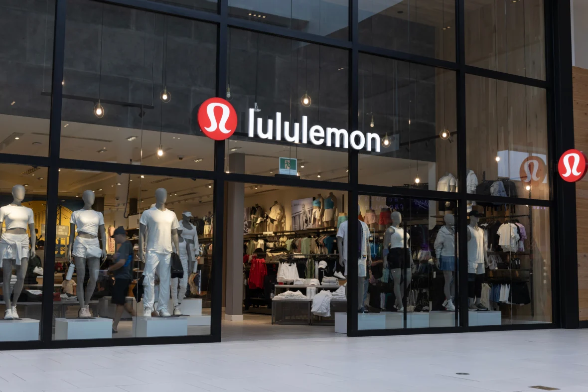 Lululemon storefront with large glass windows showcasing athletic apparel and mannequins inside a modern retail store.