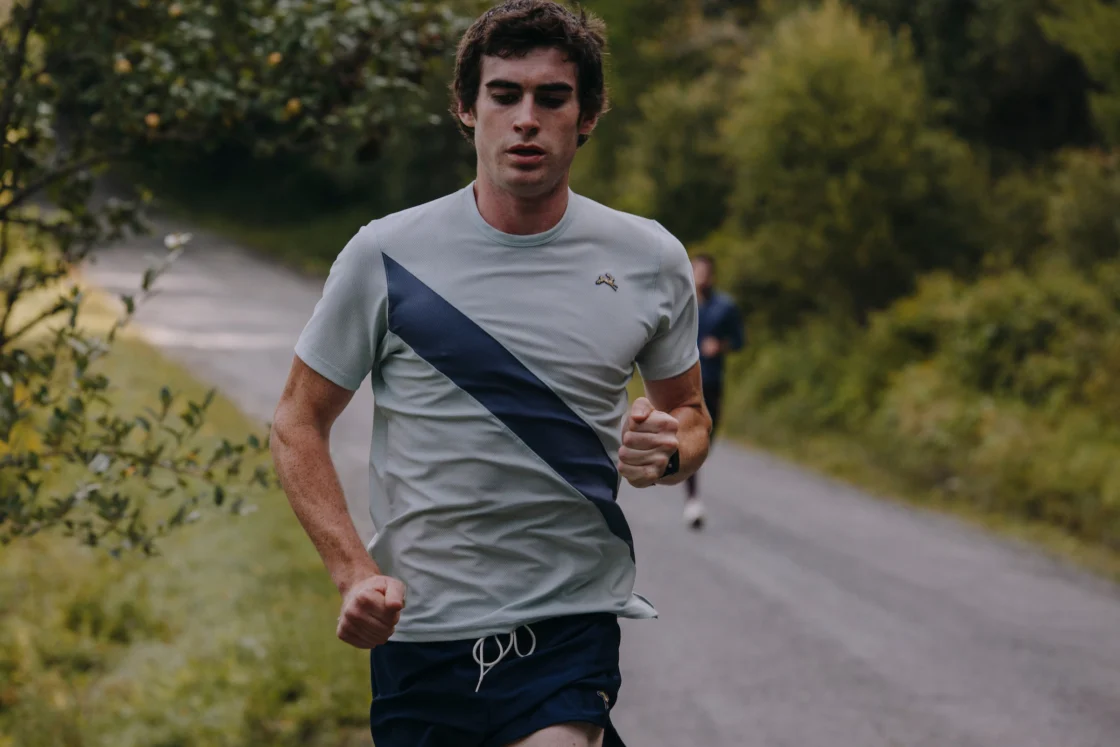 man runs in Tracksmith gear