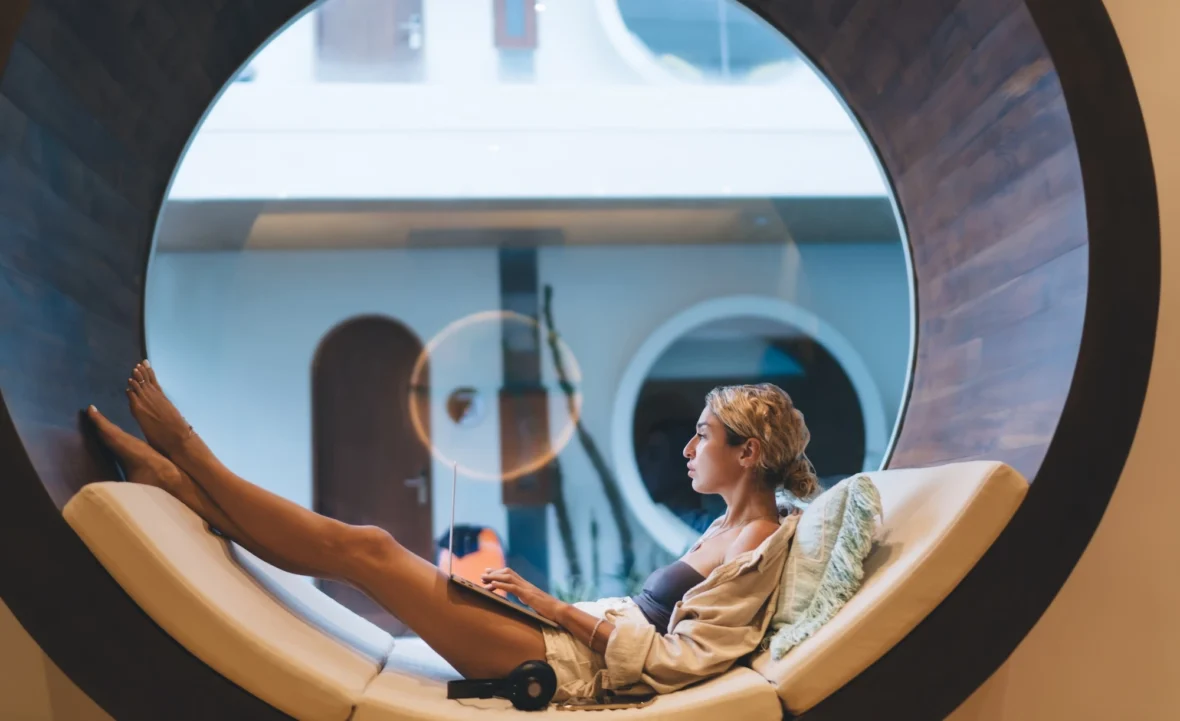 woman relaxes with her laptop in a bed