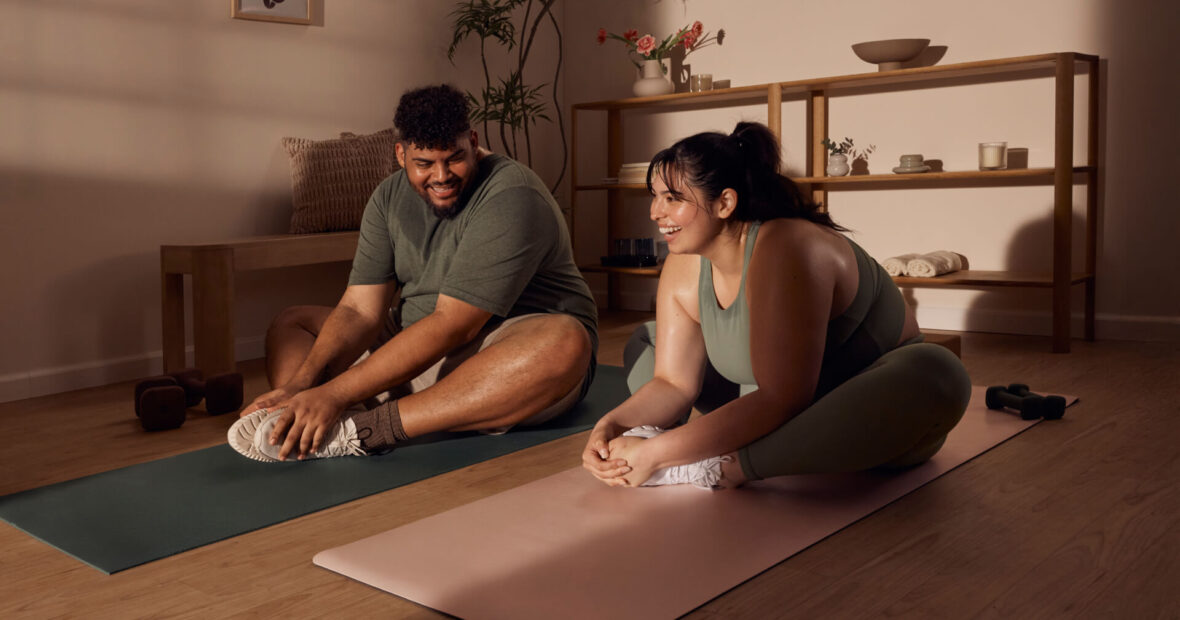 overweight man and woman do yoga together