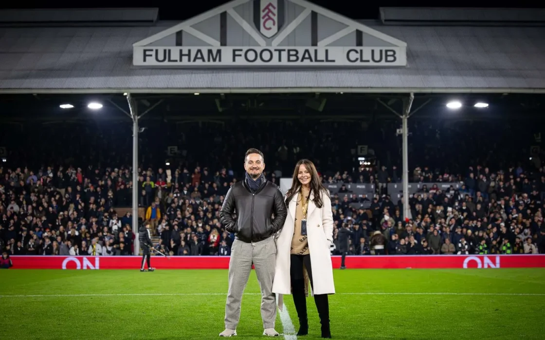 Andy and Katie Mant of Bon Charge on the pitch at Craven Cottage