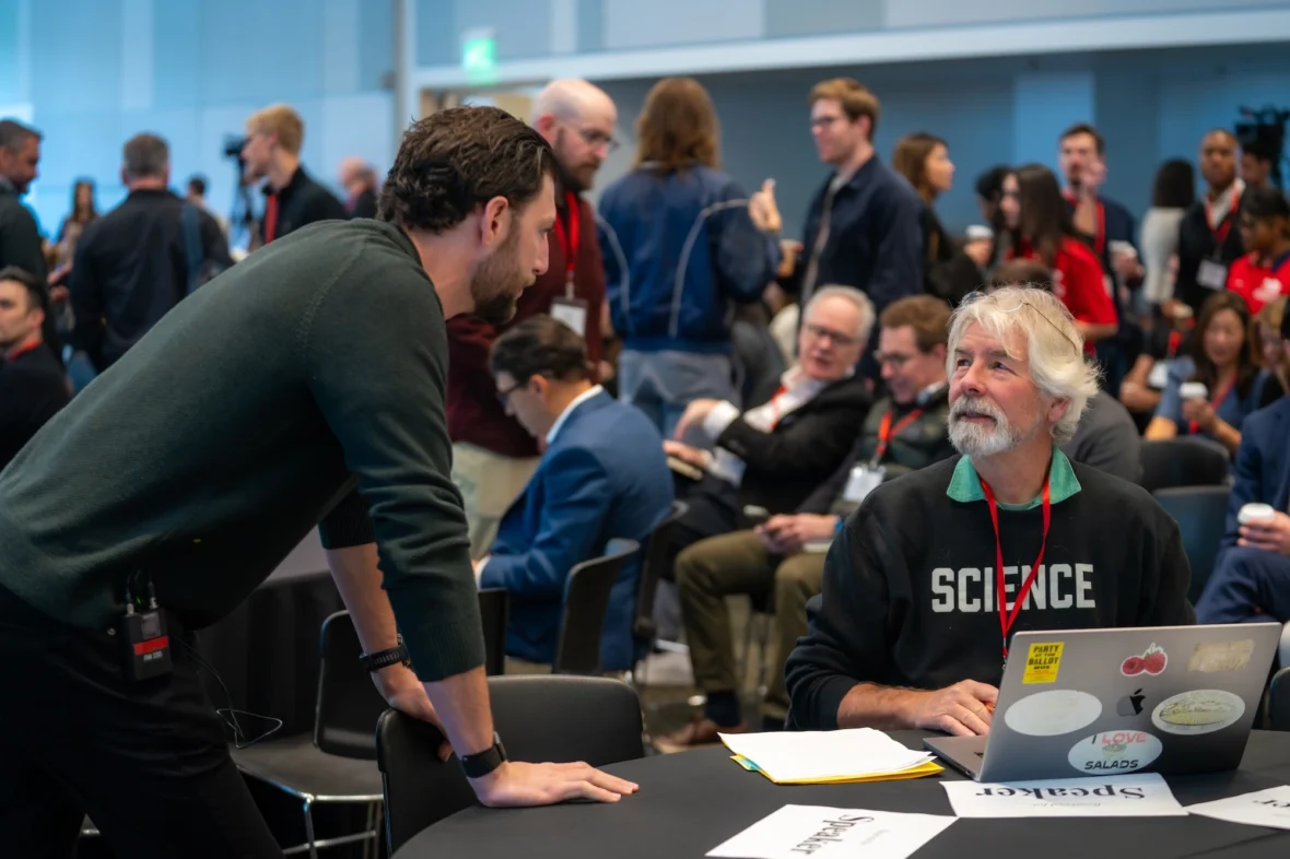 Event founder Zach Teiger speaks with an attendee at the Stanford Consumer Health Conference