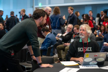 Event founder Zach Teiger speaks with an attendee at the Stanford Consumer Health Conference