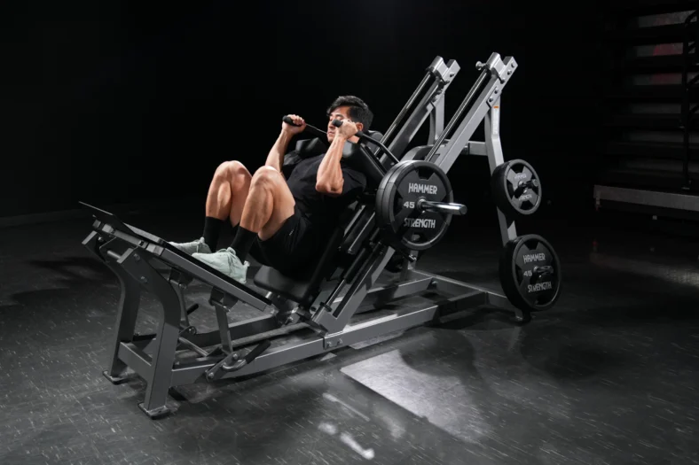 man uses a Hammer Strength leg machine