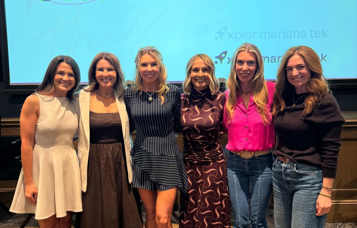 women pose for a photo at an Xplor Technologies event
