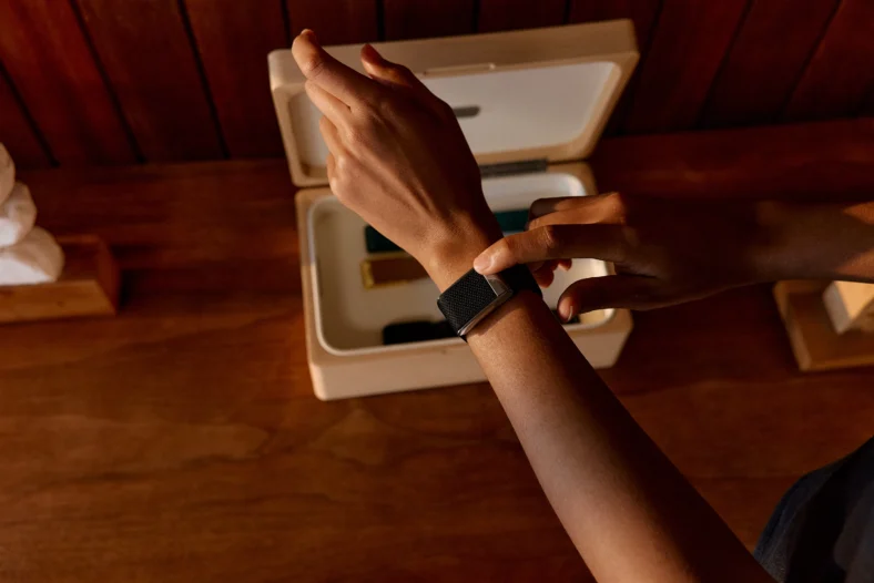 An arm with a Whoop band on the wrist.