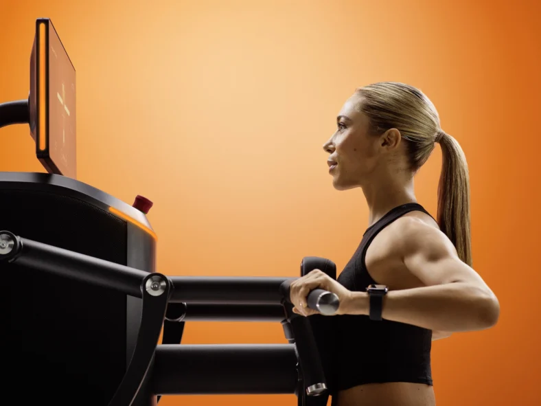 woman uses an EGYM strength machine