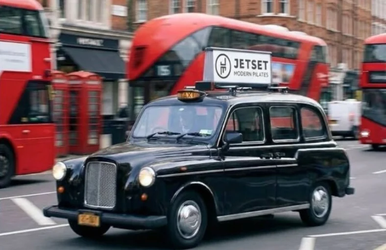 car in london with a JetSet Pilates advertisement