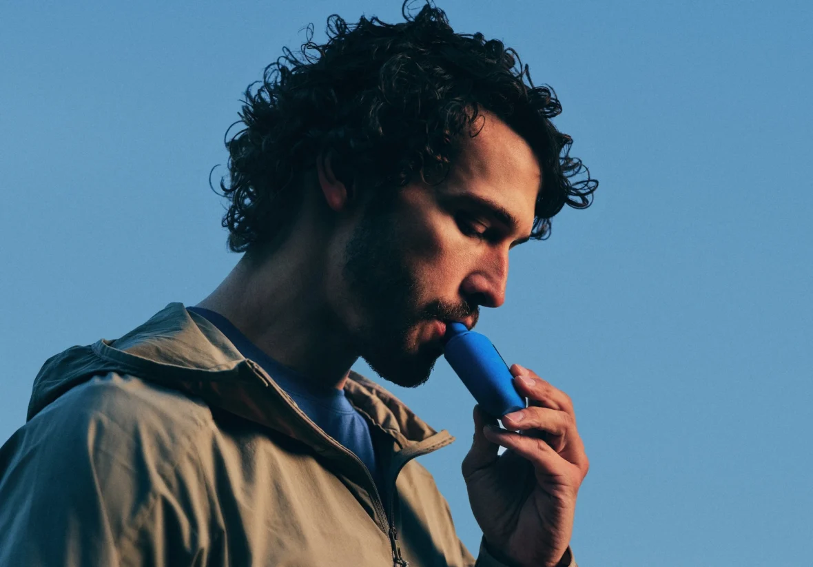 man inhales on a Climatic lung health device