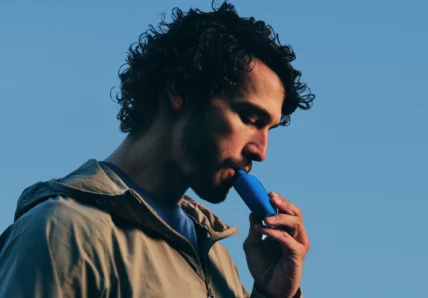 man inhales on a Climatic lung health device