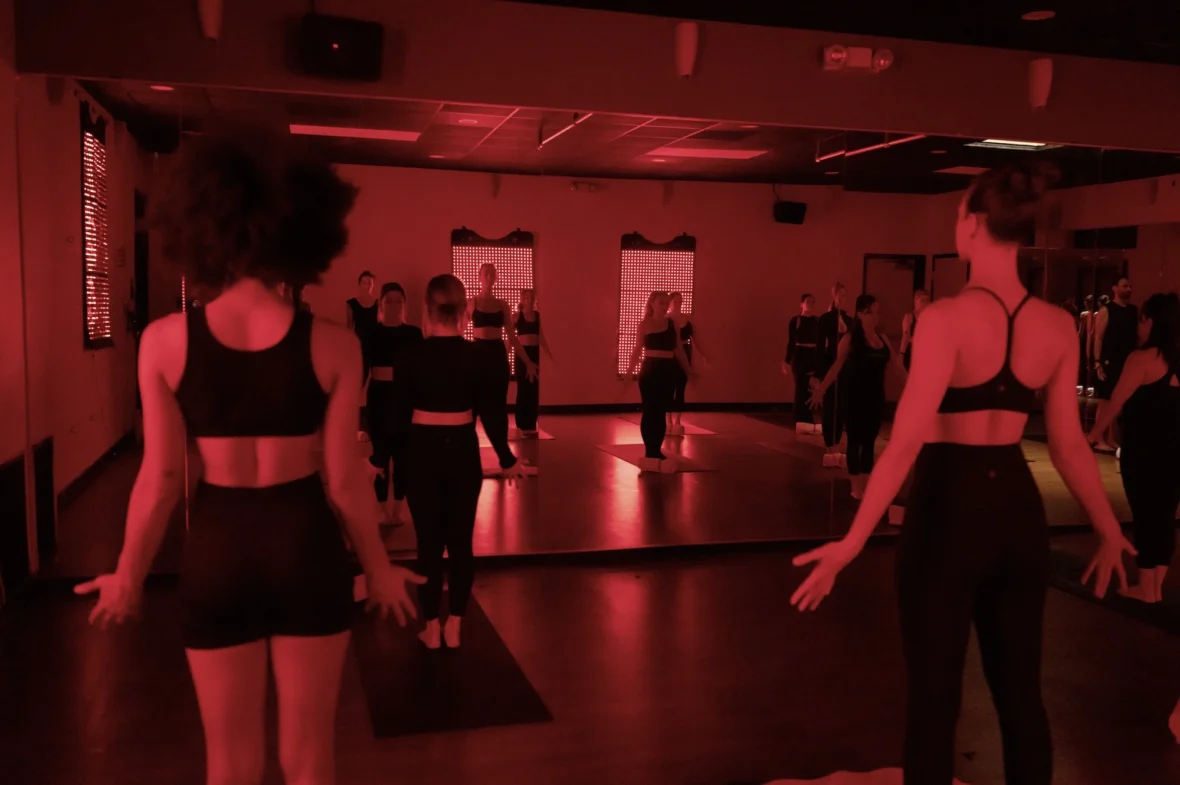 women do yoga inside a red light room