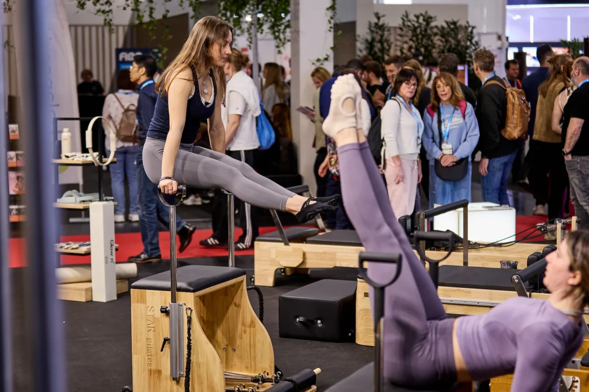 women on Pilates machines at a fitness trade show