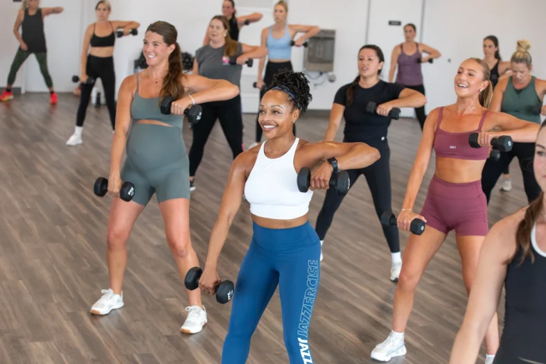 women lift weights in a Jazzercise class