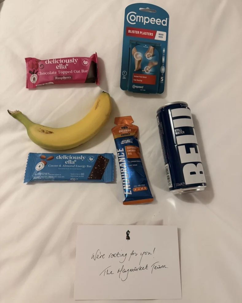 healthy snacks and a handwritten note on a bed