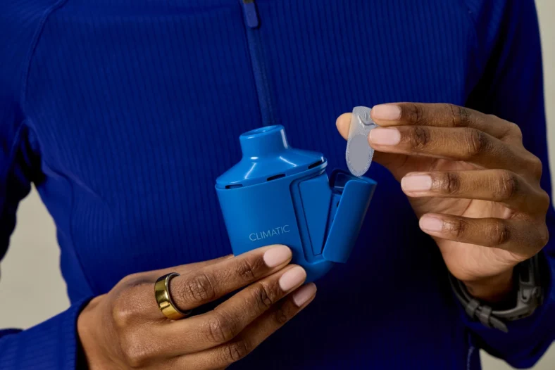 woman holds a Climatic L Max device
