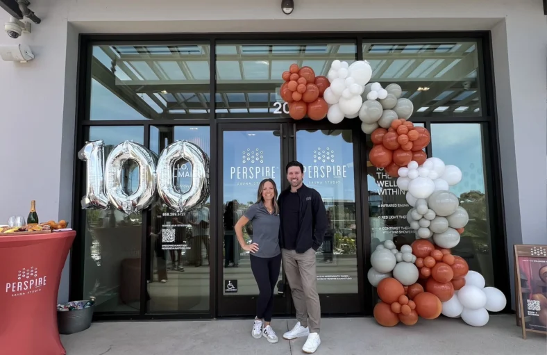 Perspire's founder and franchise owner pose in front of the brand's Del Mar location