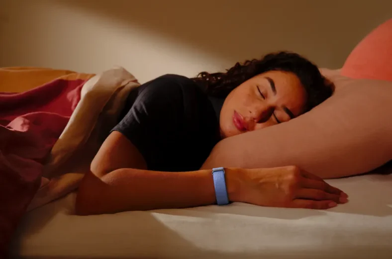 woman sleeps while wearing the Google Fitbit Air
