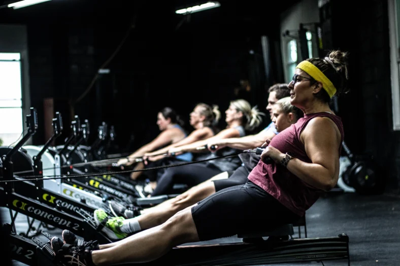 people on rowing machines at a Mecka Fitness
