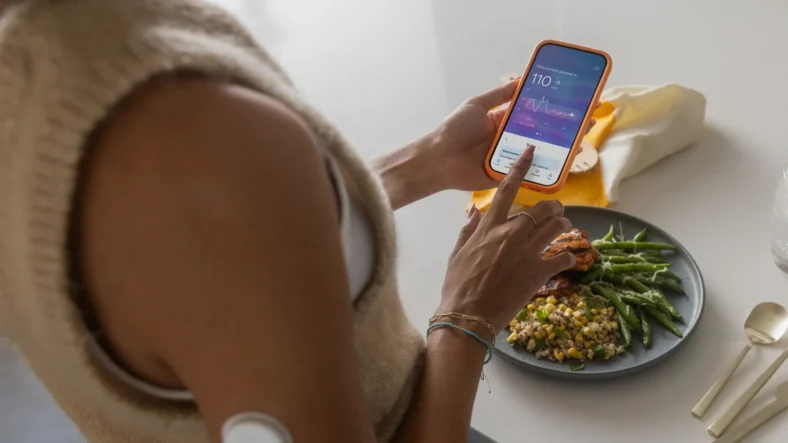 woman uses a wellness app on her phone